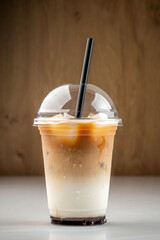 Iced latte in takeaway plastic cup