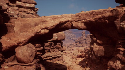 A majestic stone arch rises above the rugged terrain in a serene desert setting.