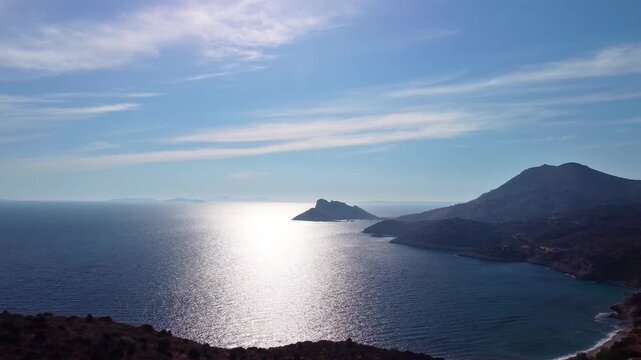 aerial footage showcasing the stunning coastal landscape and the shimmering Mediterranean Sea on the scenic route to the historic Knidos Ancient City in Datça, Turkey. This video captures the natural