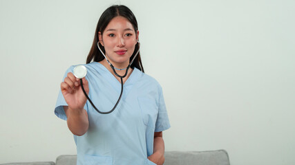 Nurse demonstrating stethoscope use in healthcare setting educational image professional...