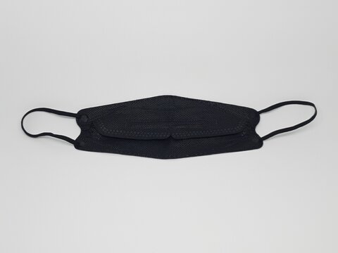 Black reusable cloth face mask isolated on white background, protection against dust and germs