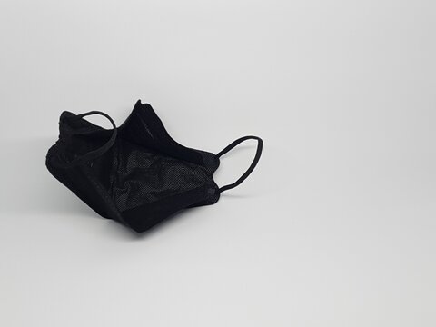 Black reusable cloth face mask isolated on white background, protection against dust and germs