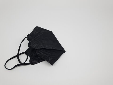 Black reusable cloth face mask isolated on white background, protection against dust and germs