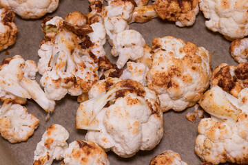 Oven-baked cauliflower florets topped with a flavourful sauce made from olive oil, sweet paprika, garlic, and cumin - perfect for a healthy dinner..