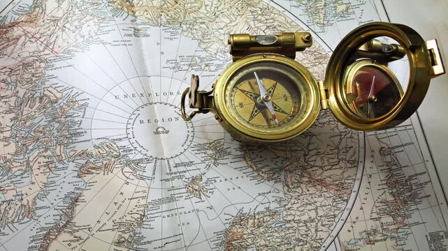 Antique compass on a Victorian Map from 1890  showing unexplored areas of the world 