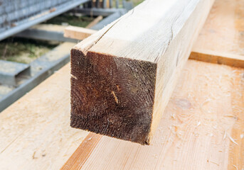 Close-up of wooden beam with rough texture on construction site