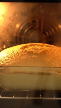 Baking a cake in an oven with warm lighting and rising batter