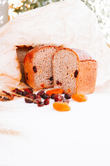 Delicious homemade bread with dried fruit displayed on a sunny table outdoors