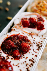 Delicious dessert with cream and fruit topping served in a dish at a cafe