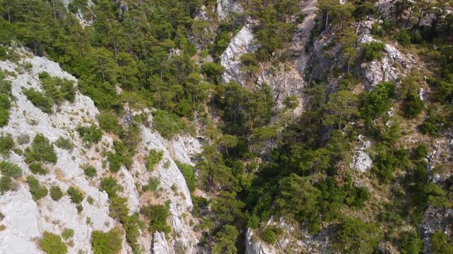 Experience the beauty of Turkey's Mediterranean coast with this stunning aerial footage capturing Kelebekler Vadisi Butterfly Valley and the majestic Babadag Mountain. Witness the dramatic cliffs, lus