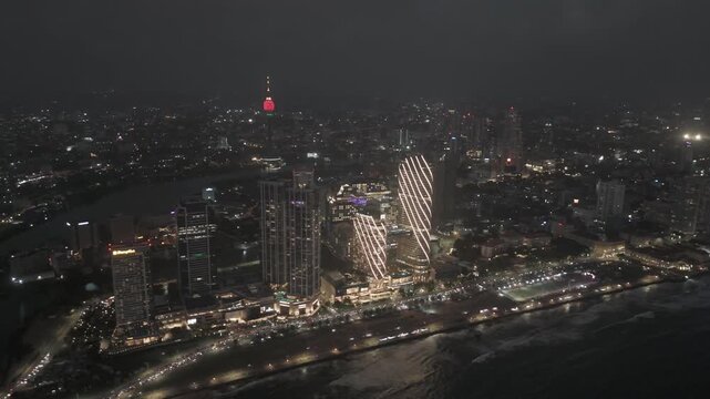 Aerial Drone View of Colombo Skyline at Night, Sri Lanka &ndash; Illuminated Cityscape with Skyscrapers and Harbor Lights