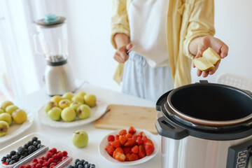 Healthy senior woman in her kitchen. Mature woman serving herself wholesome vegan food at home. Woman taking care of her aging body with a plant-based diet.
