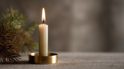 Close-up of a single white candle in a gold-colored candle holder. the candle is lit and the flame is burning brightly.