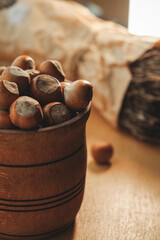 Freshly harvested hazelnuts in a rustic wooden bowl in a cozy setting