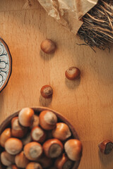 Gathering of hazelnuts on a wooden surface with decorative pottery