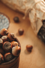 Freshly gathered hazelnuts resting in a rustic wooden bowl on a table