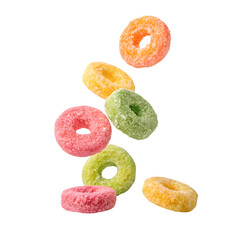 Assortment of colorful fruit flavored cereal rings tumbling and falling in mid air isolated on transparent background