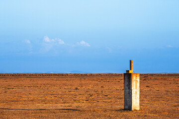 Concrete water gauge in a dry lucio at Doñana National Park