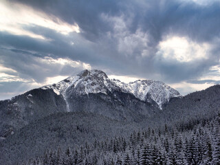 Fototapeta premium clouds over the snow-covered mountain peaks