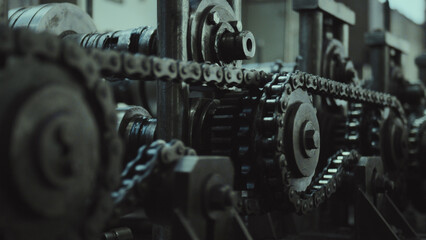 Industrial chain drive system with gears and sprockets operating, representing concepts of heavy...