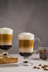 Layered coffee latte drinks. Hot coffee drinks in glass mugs