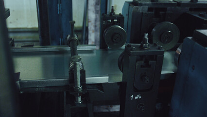 Industrial machine precisely processing a metal sheet, reflecting a commitment to modern manufacturing, automation, and industrial production of various components in a factory setting