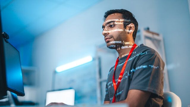 Indian programmer coding typing keyboard in modern office software developer programming IT technology career