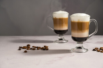 Layered coffee latte drinks. Hot coffee drinks in glass mugs, copy space