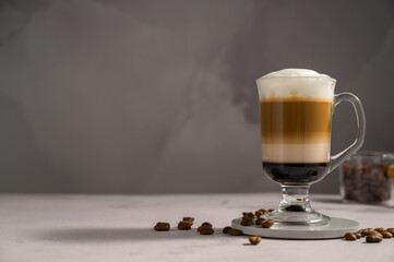 Layered coffee latte drinks. Hot coffee drinks in glass mugs, copy space