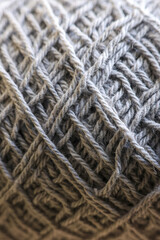 Gray wool yarn with detailed texture in macro close up view. natural fiber and thread wound on ball create cozy and warm pattern for knitting or craft project