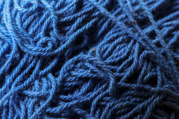 Close up macro background of blue yarn wool texture. soft fiber thread detail for cozy knitting or...