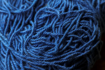 Chaotic texture of tangled blue yarn and wool fiber. This soft, messy thread makes perfect background for creative knitting or craft project, feeling complex
