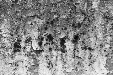 Dramatic black and white abstract background showing rough, weathered, and textured concrete surface. This grunge stone wall has gritty, aged appearance great for design