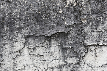 Macro shot of weathered gray concrete wall background with rough, grunge texture. old cement surface shows signs of decay, with cracks and an abstract pattern