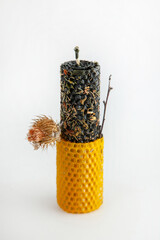 Bee-inspired beeswax ritual candle for wealth and protection with herbs and burdock