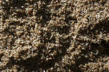 Macro background of brown granular sand showing coarse natural texture. abstract crystal pattern evokes feeling of simple, earthy detail and pure material
