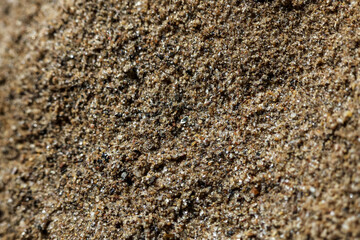 Brown sand texture background shows detailed surface and grain in macro close up. This natural material pattern creates simple, earthy feeling for any design