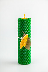 Natural wax candles with bay leaf and dried orange for rituals and space cleansing