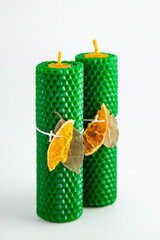 Natural wax candles with bay leaf and dried orange for rituals and space cleansing