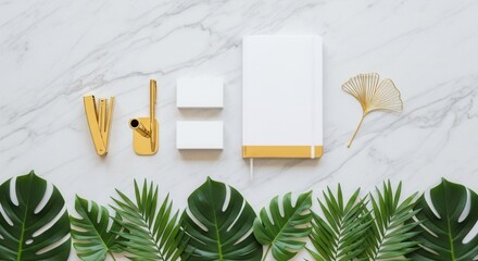 Flat lay of gold office supplies blank cards a notebook and tropical leaves on marble