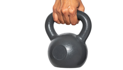 A hand gripping a heavy kettlebell, showcasing a workout tool designed for strength training and fitness exercises.