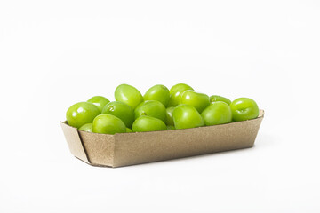 Fresh green grapes in a cardboard box on a white background. Isolated. Side view