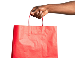 A hand holds a vibrant red shopping bag, showcasing its handles and textured surface.