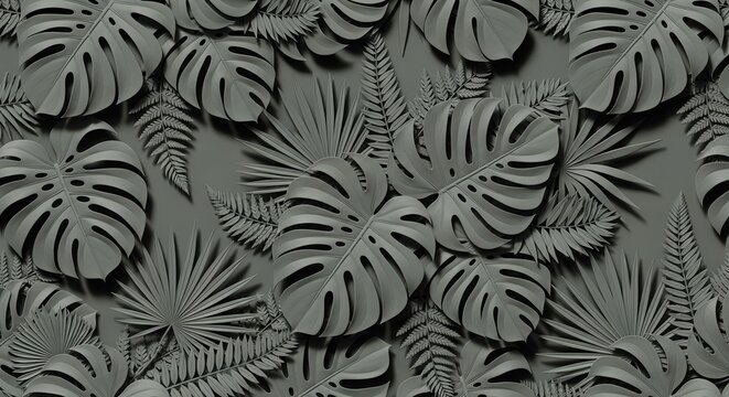 Monochromatic arrangement of tropical foliage textured monstera palm and fern leaves layered with shadows on a solid gray background