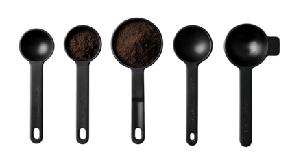 Five black measuring spoons filled with ground coffee