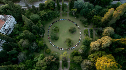 Sunrise yoga garden circle of people practicing meditation in leafy park creating calm communal energy