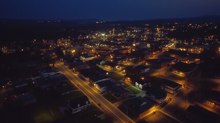 Fototapeta premium Aerial night view illuminating small town cityscape