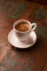 Fototapeta premium Cup of coffee on rustic wooden background. Soft focus. Copy space 