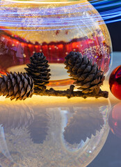 Christmas ball with Christmas decorations, pine cones and colored balls
