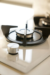 Gas stove burner on kitchen countertop with bright natural light